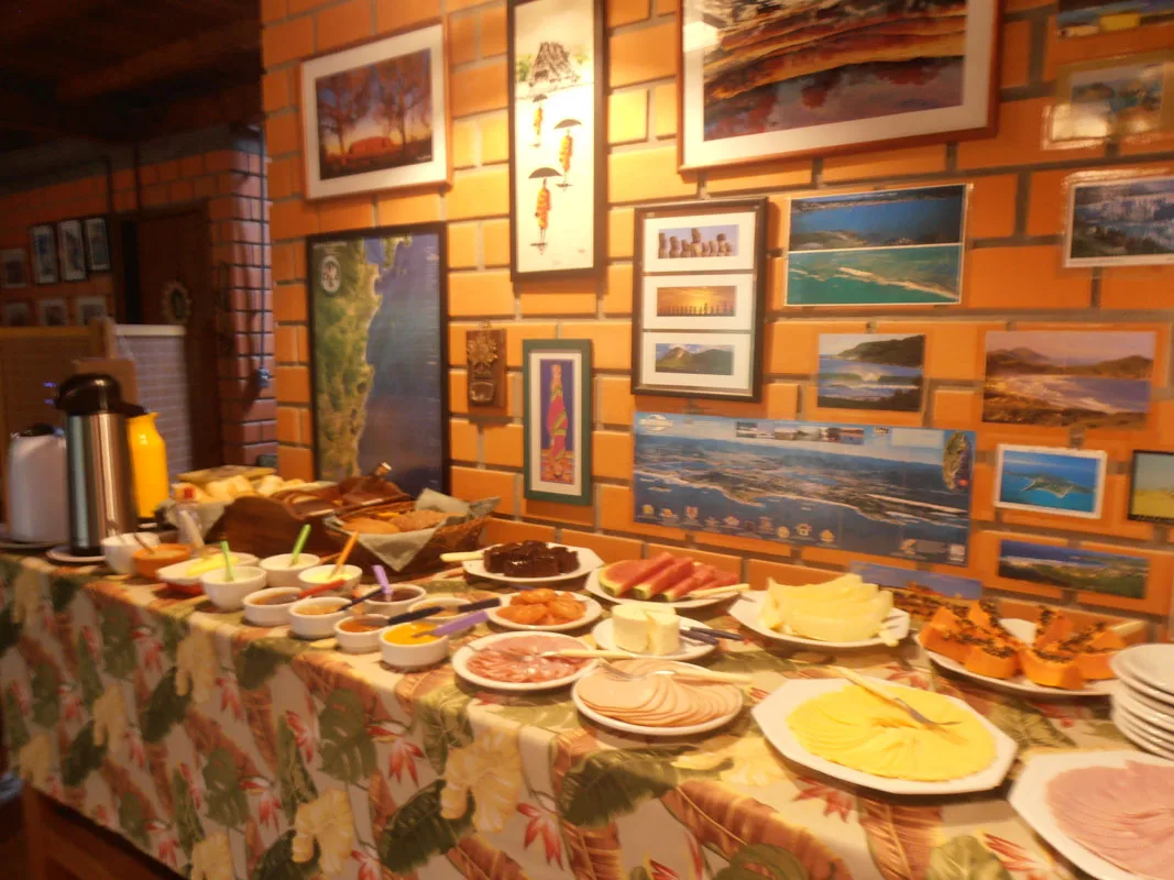 Mesa do café da manhã com bolos, pães e frios